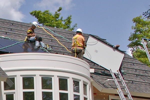 solar panels being installed on a green home in CT