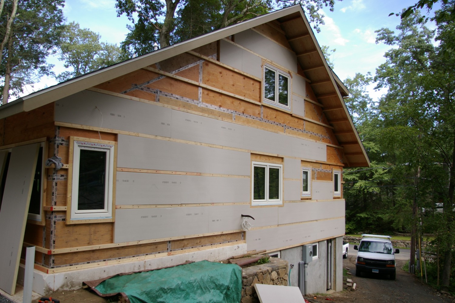 Exterior walls with taped sheathing and first layer of foamboard insulation